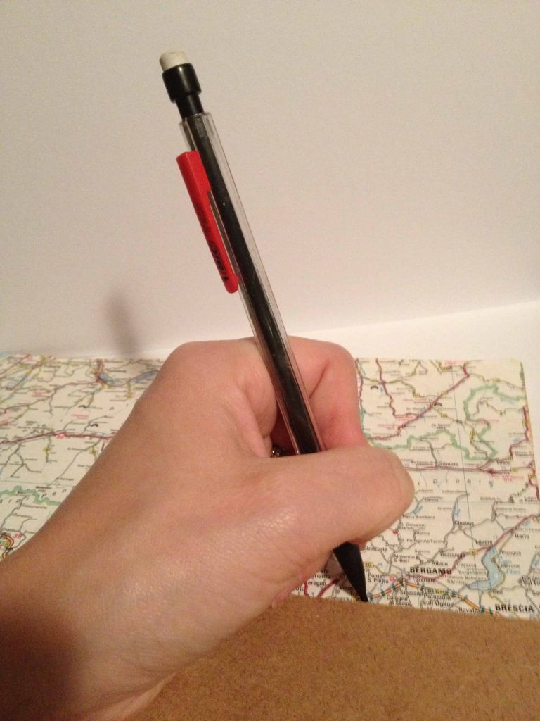 Using a pencil to trace out the size of the shadow box background onto the vintage map.