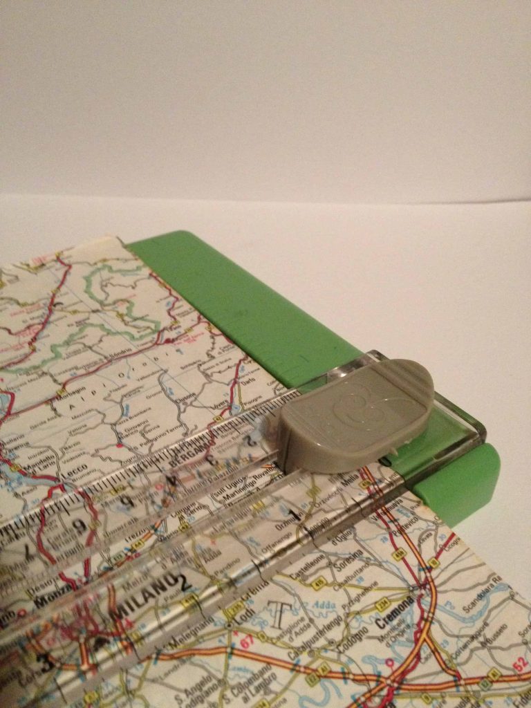 Using a paper trimmer to cut the vintage map perfectly down to the size of the shadow box background.