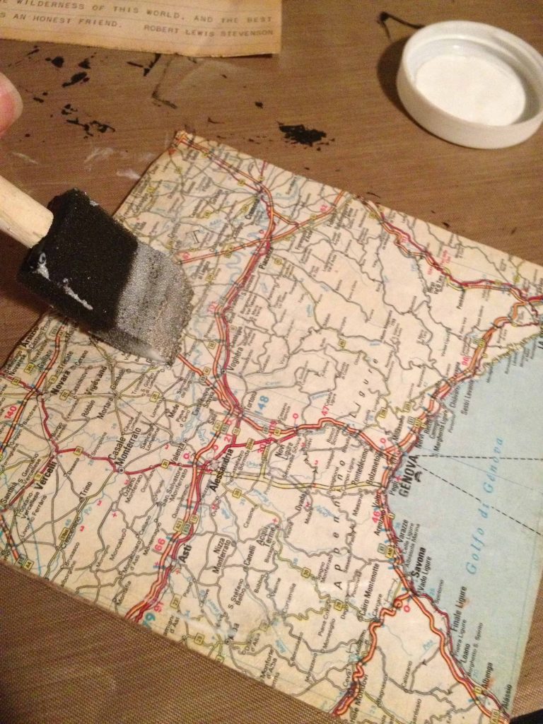 Use a craft sponge to gently smooth out the vintage map on the shadowbox background.