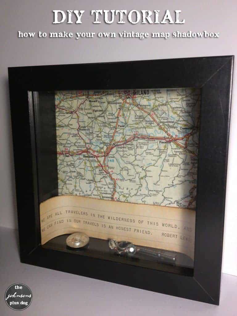 Learn how to make this vintage map shadow box craft! Image shows a black framed shadow box with a vintage map background, traveling quote, and a key inside the box.