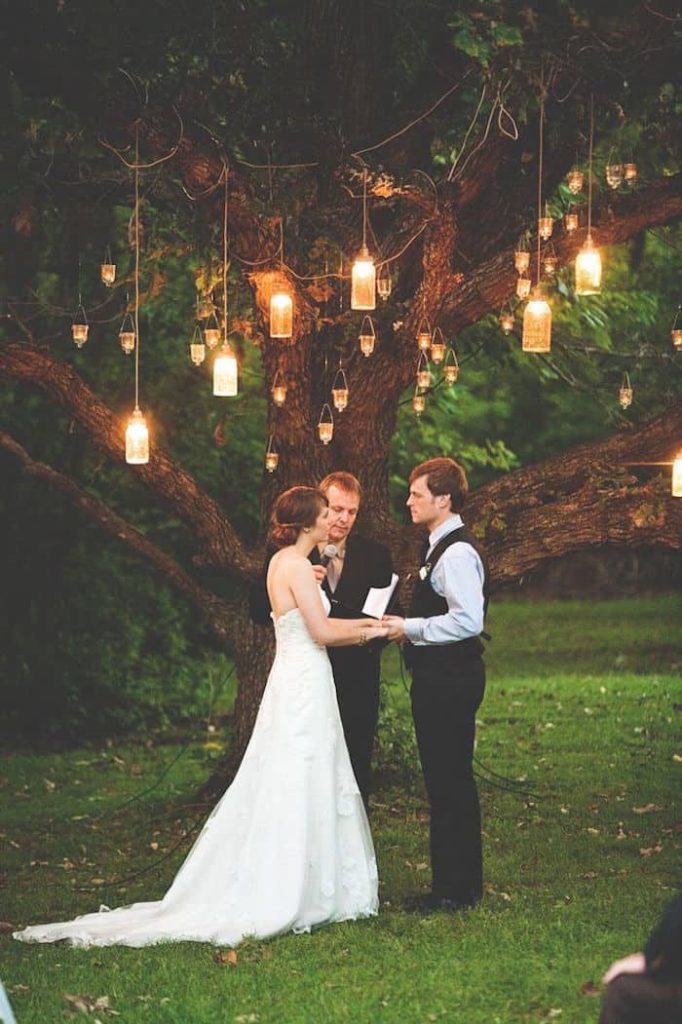 Creative Wedding Ceremony Decor Ideas | Hang mason jar candles from the trees for a romantic feel at your wedding ceremony