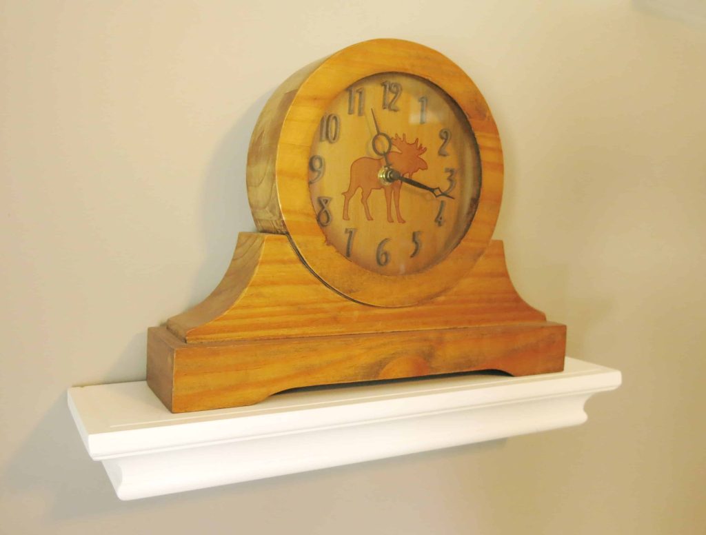 wooden clock with a moose design on the face