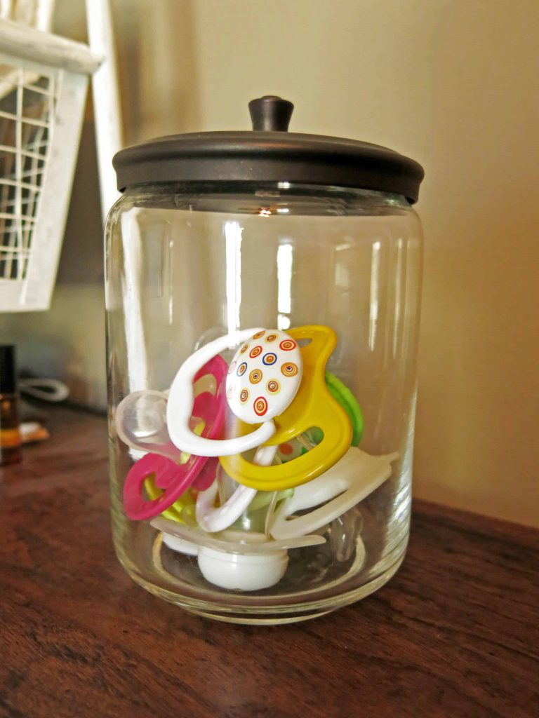 pacifiers in a glass jar with a lid