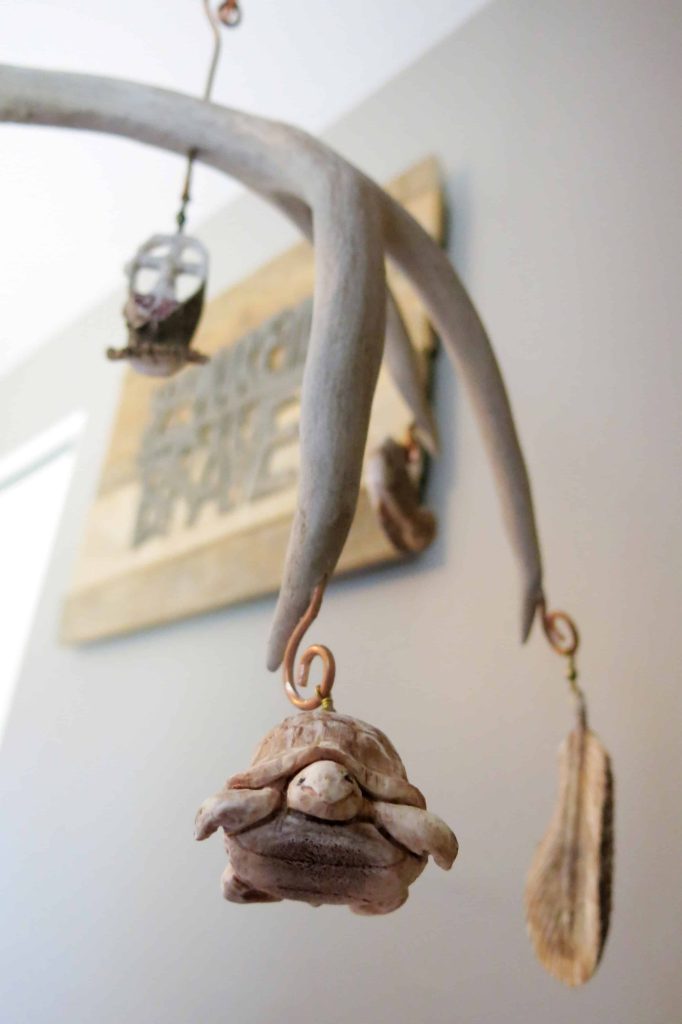 close up detail shot of a turtle charm on an antler mobile