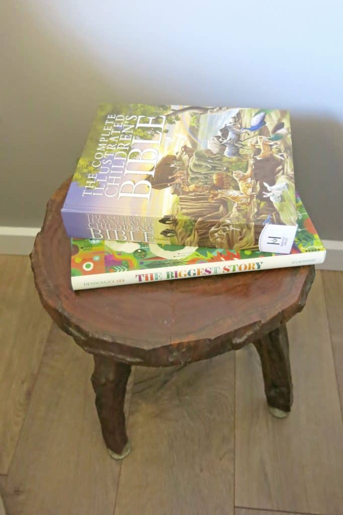 two children's books on a wooden stool