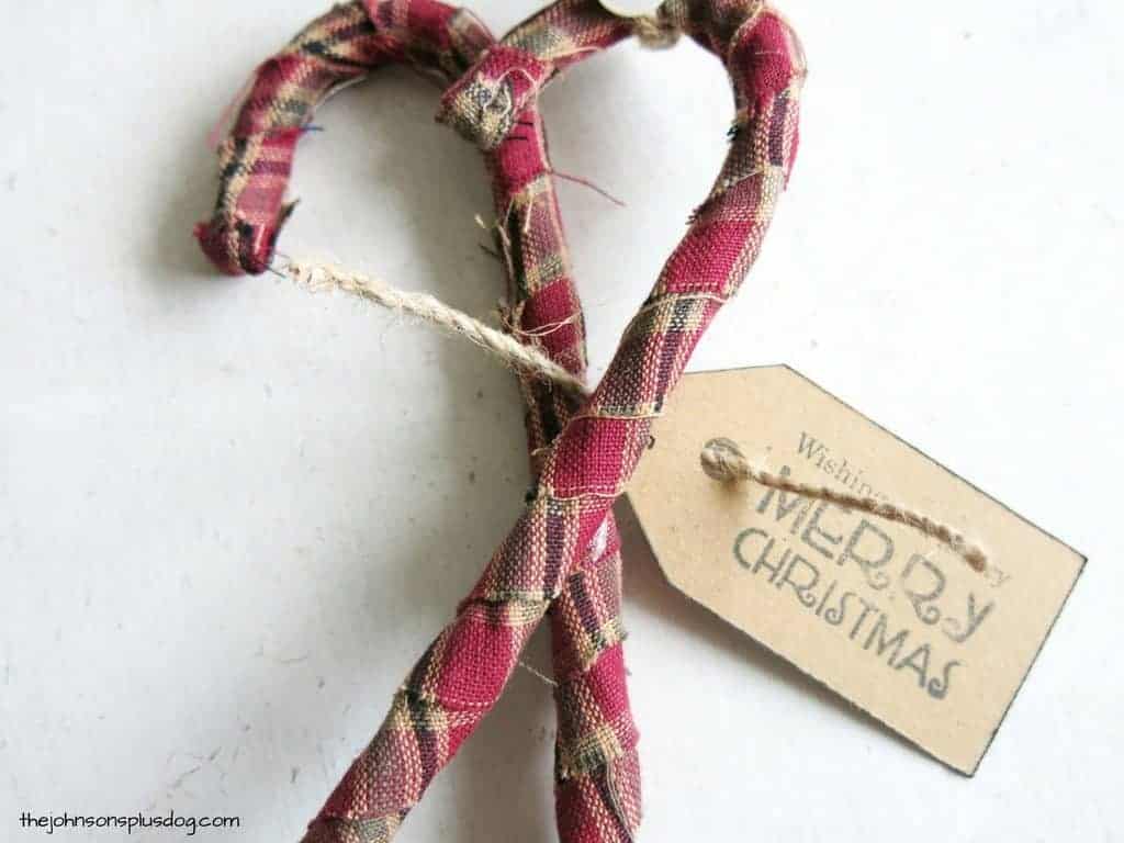 A stamped gift tag and a piece of jute string tied around the homemade fabric ornaments