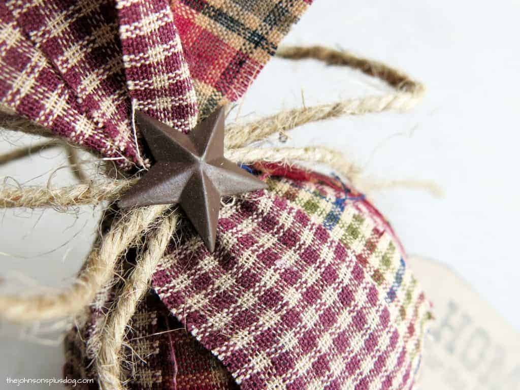 A close up look at the rustic accent star on this homemade fabric ornament.