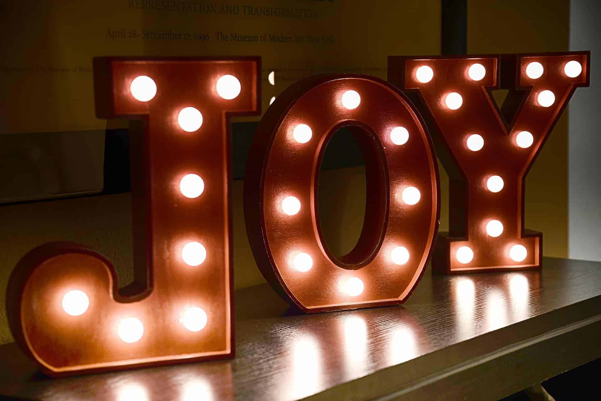 Lightbox letters spelling out JOY sitting on table