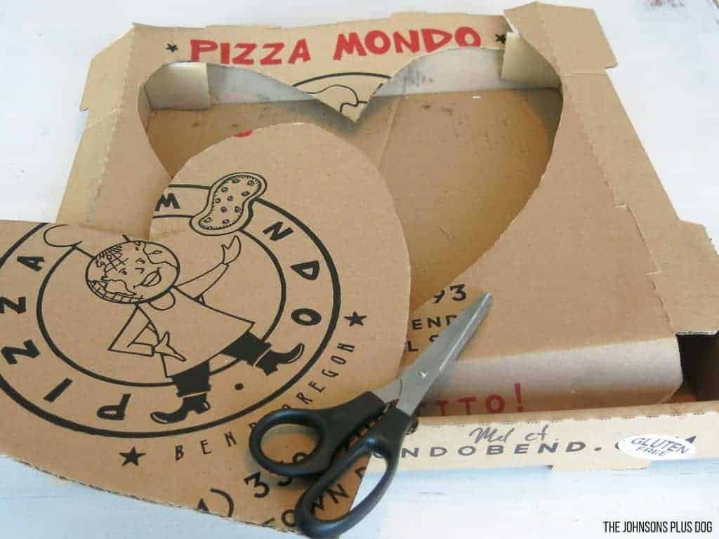 Heart shape cut out and scissors from pizza box cardboard