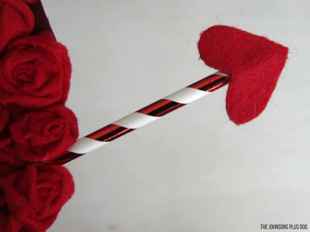 Close up of little heart felt attached at the end of the red and white straw