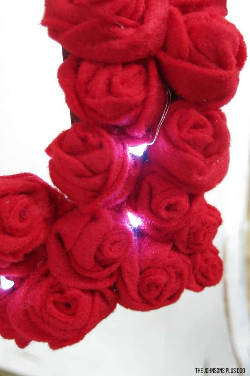 Close up of Felt Rosette Valentine's Day Wreath DIY with lights turned on