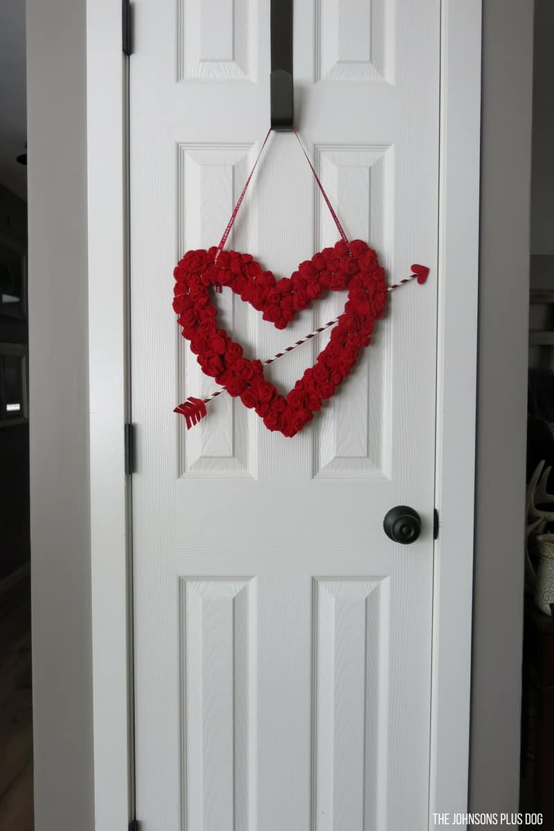 Felt Rosette DIY Valentine's Day Wreath hanging on the white door