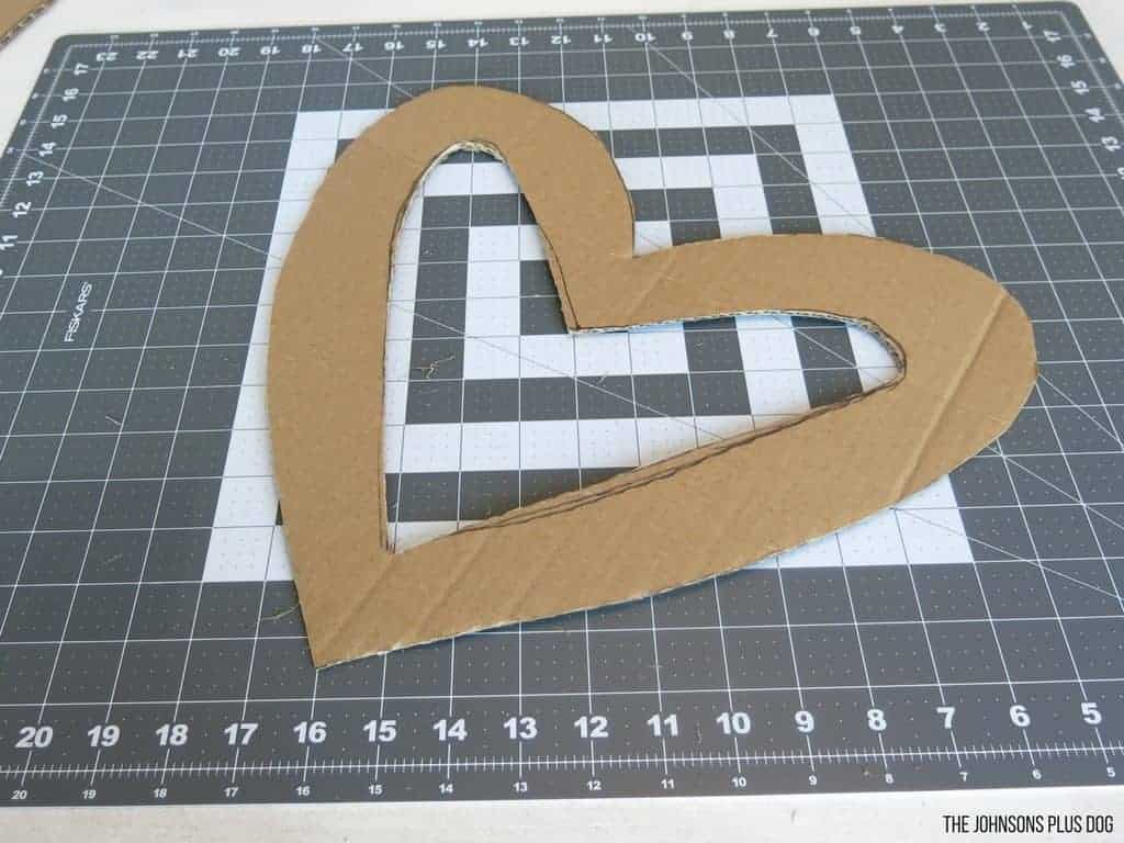 Heart shaped cardboard laying on cutting mat