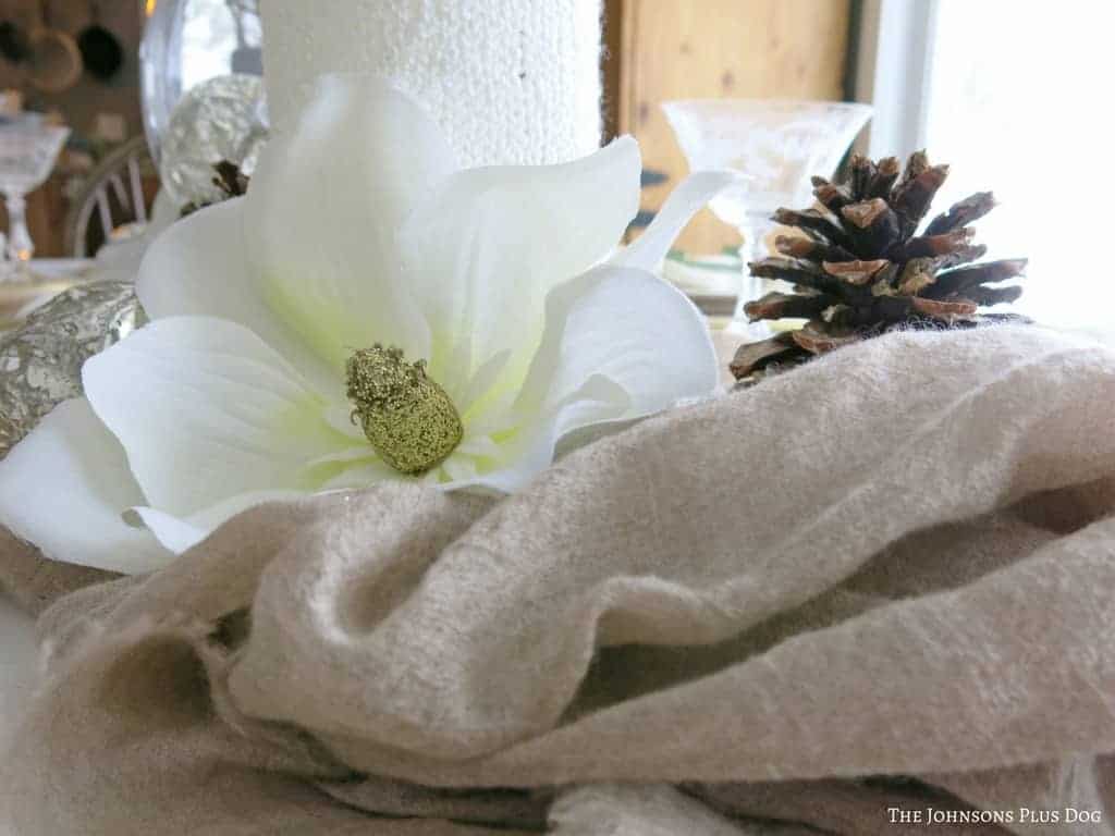 Magnolia blooms are the perfect pop of floral in this neutral winter themed tablescape