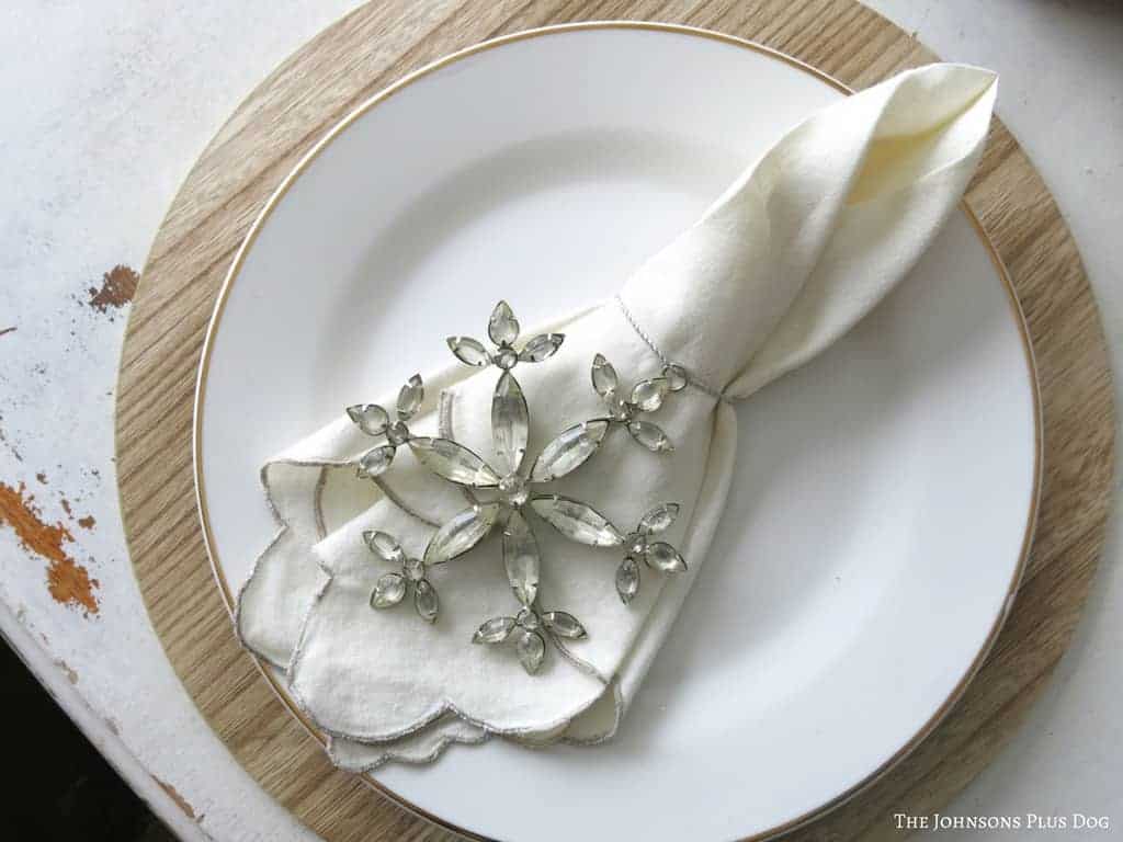 Snowflake ornaments make perfect napkin holders in this winter tablescape