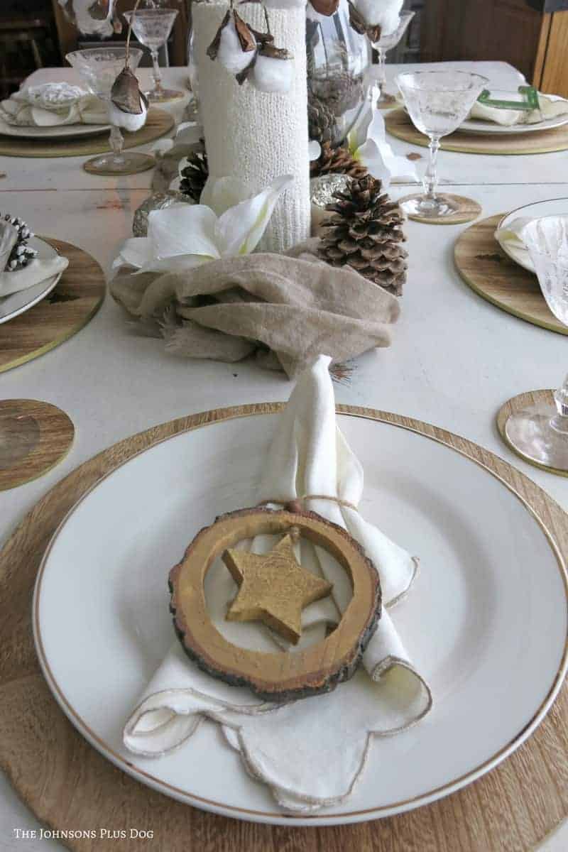 Using ornaments as napkin holders is a great way to make use of Christmas decor in your winter tablescape