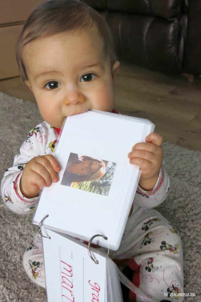 Baby Cal taking a bite out of his DIY laminated family photo book! This baby photo book idea is kid-friendly and will make a great memory as they grow older.