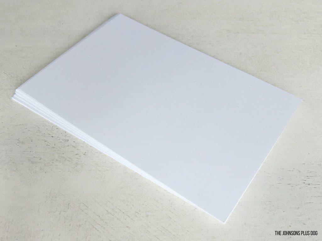 A stack of blank white cardstock that we will use to create a DIY laminated picture book for baby.