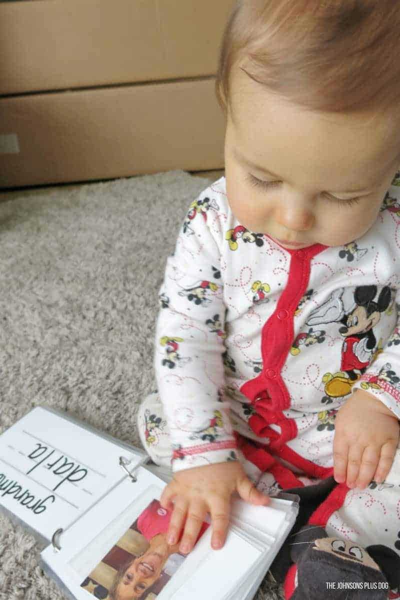 Baby Cal loves playing with his family photo book, and looking at pictures of Grama Darla.