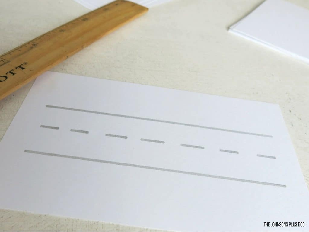 White cardstock paper with margin lines that look like kid's writing paper. We'll use these for our child's family photo book.