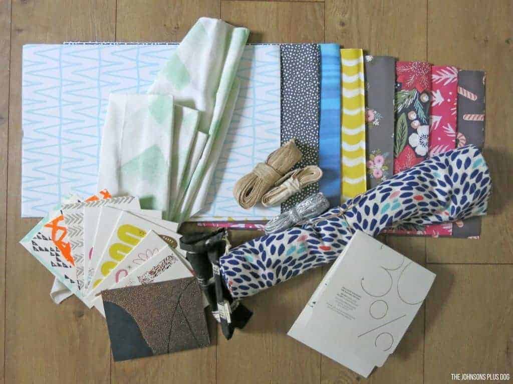 Contents from my Minted More membership welcome box - fabric swatches, a table runner, colorful cards, coupon codes and more.