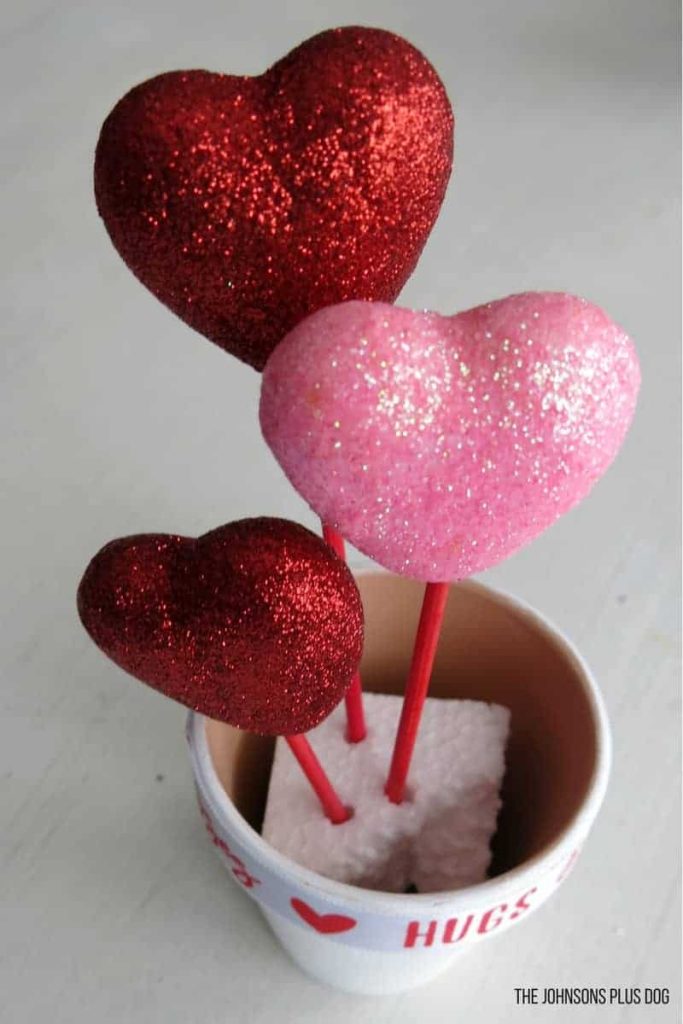 Add heart sticks to a Styrofoam block placed in the Valentines Day pot