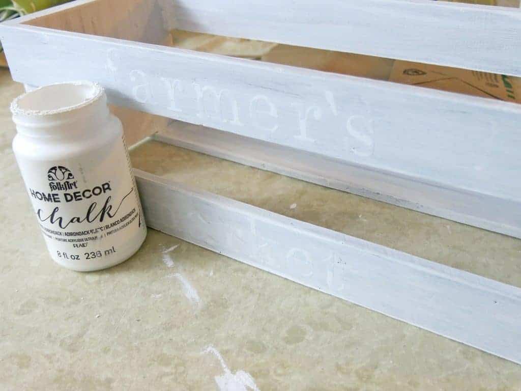 We used FolkArt white chalk paint for this farmhouse crate centerpiece to paint over sticker letters to create the words on the side of the crate