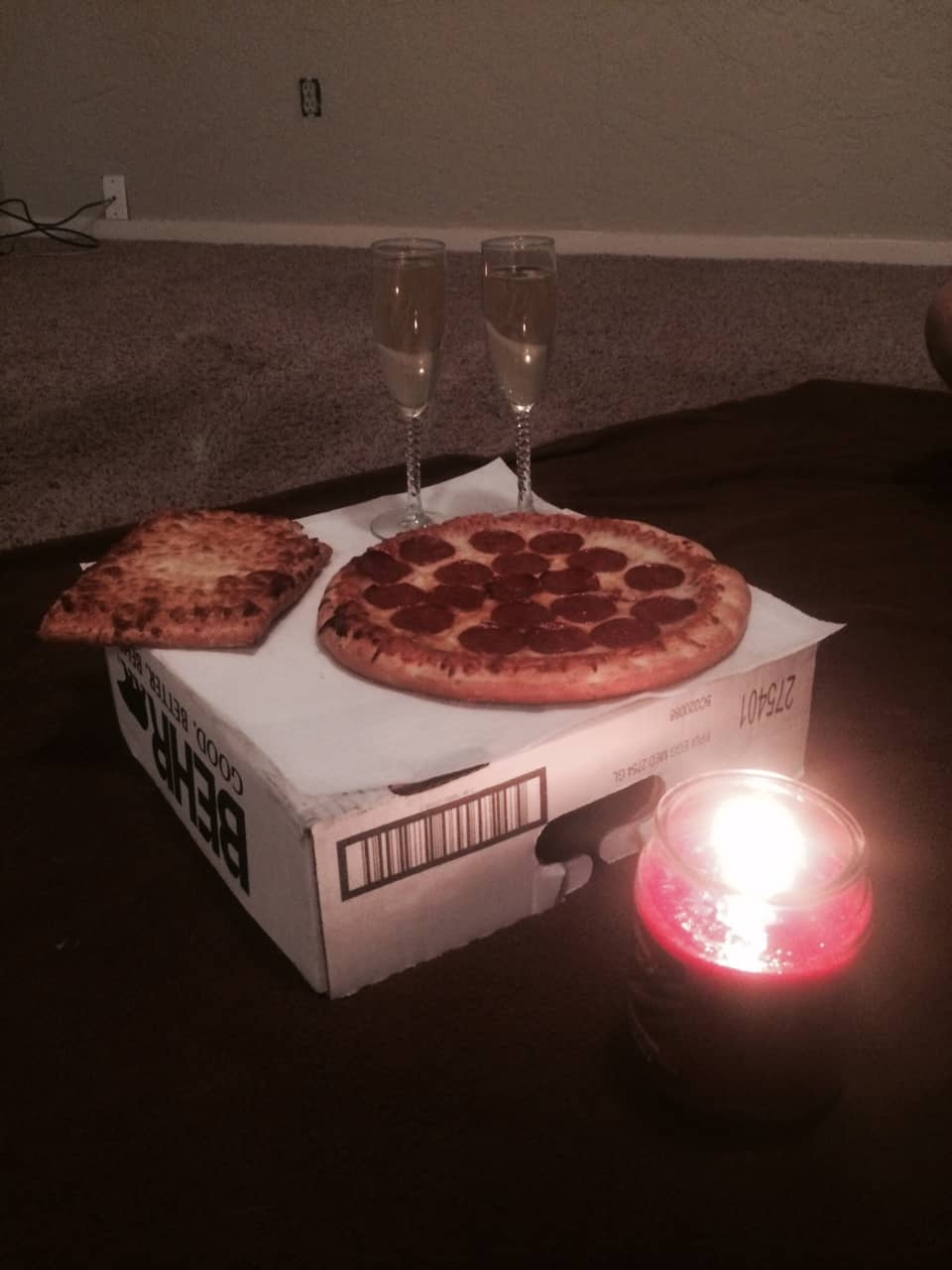 Celebrating the first night in our new home with pizza, some champaign, and a candle on a classy Behr paint box table.