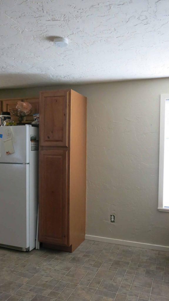 Blank spot open next to kitchen cabinets to be used for a DIY pantry