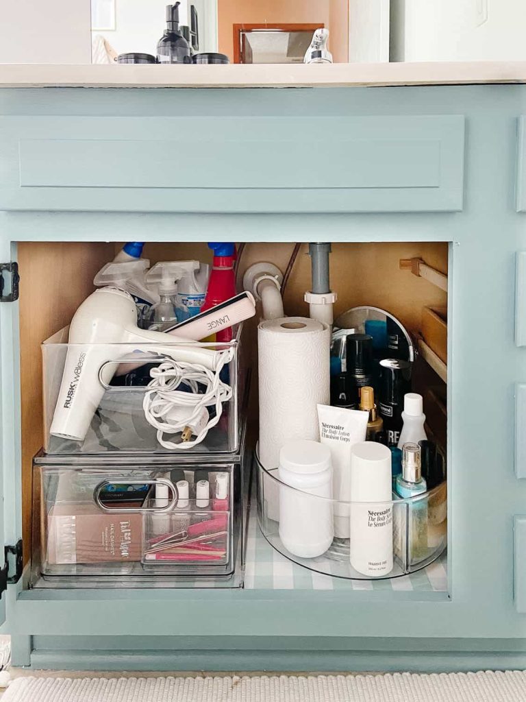 I love the idea of adding a lazy susan rotating container under the sink in your bathroom alongside clear stackable storage drawers and bins