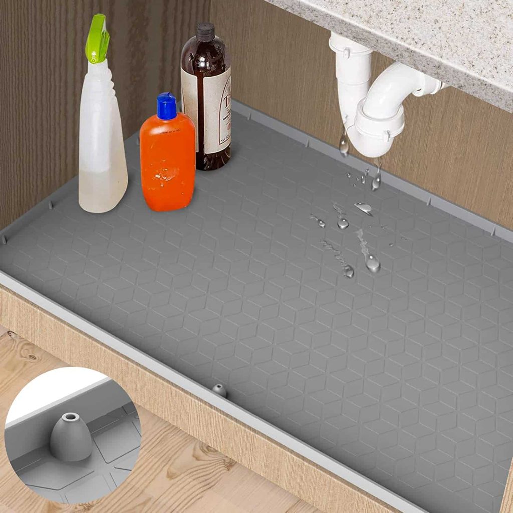 You can put down a mat, like this, to protect the bottom of your bathroom or kitchen cabinets from spills and leaks, making it easy to clean