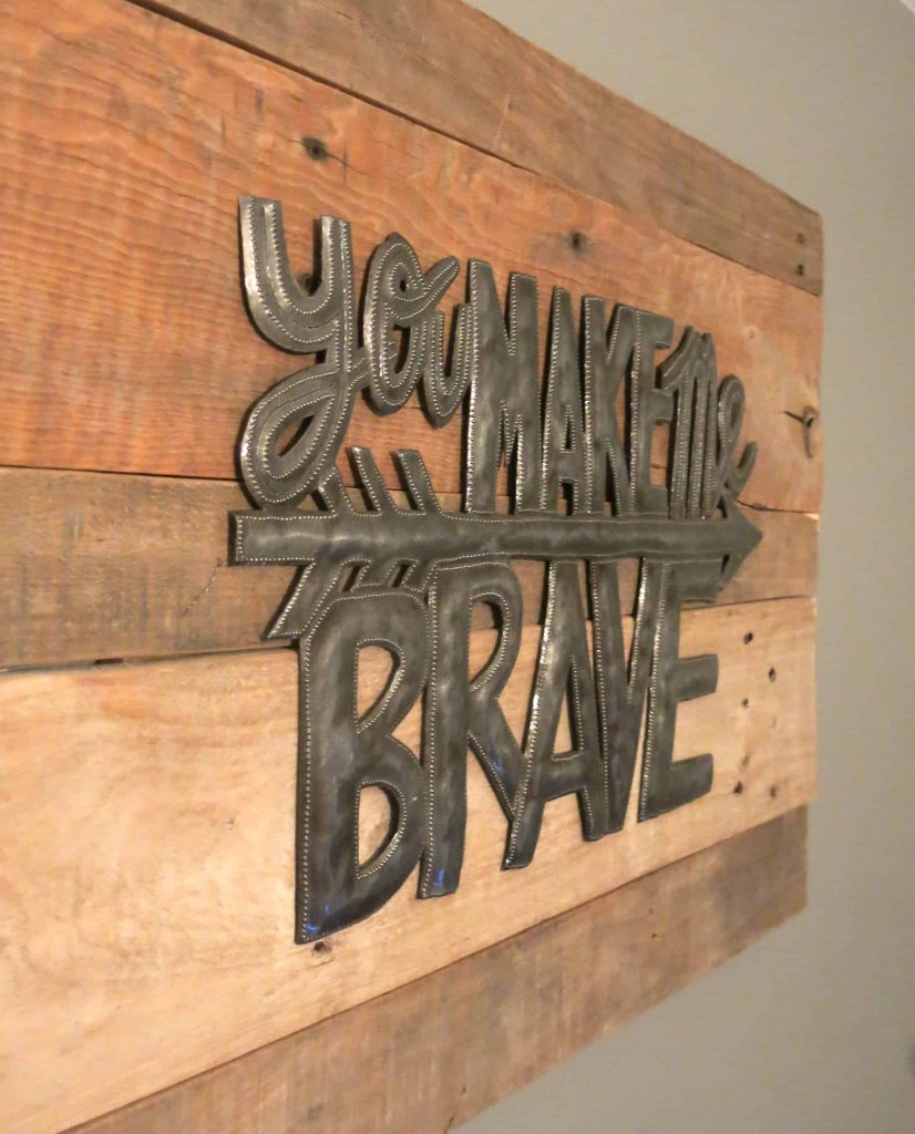 close up photo of a metal sign that reads "you make me brave" on a pallet wood sign background