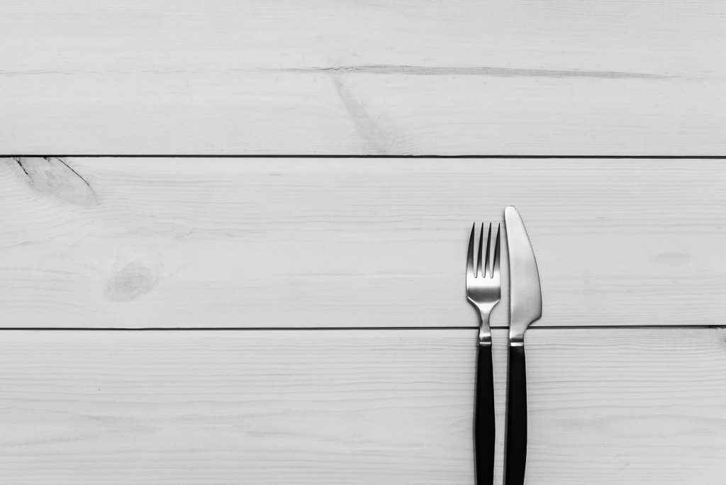 Silverware against a white shiplap background