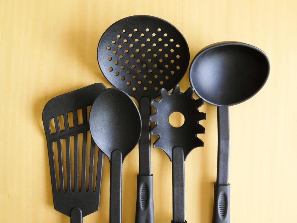 Plastic cookware against a yellow background