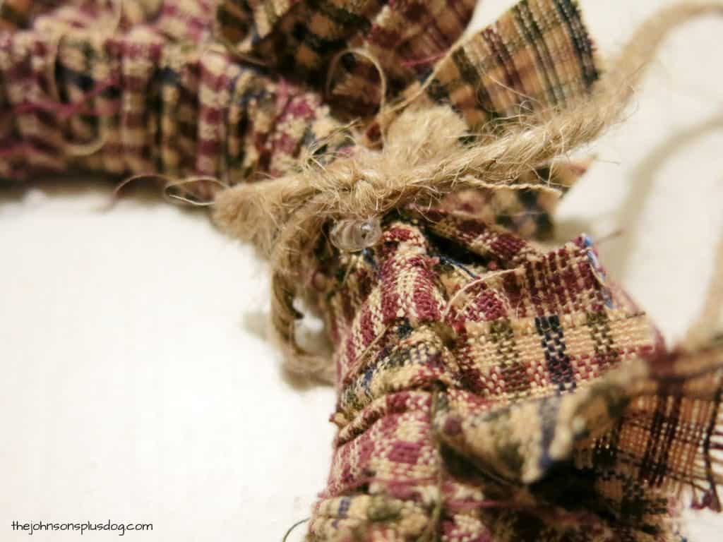 Tie a strip of jute twine around the mini wrath ornament to create a loop for hanging the ornament.