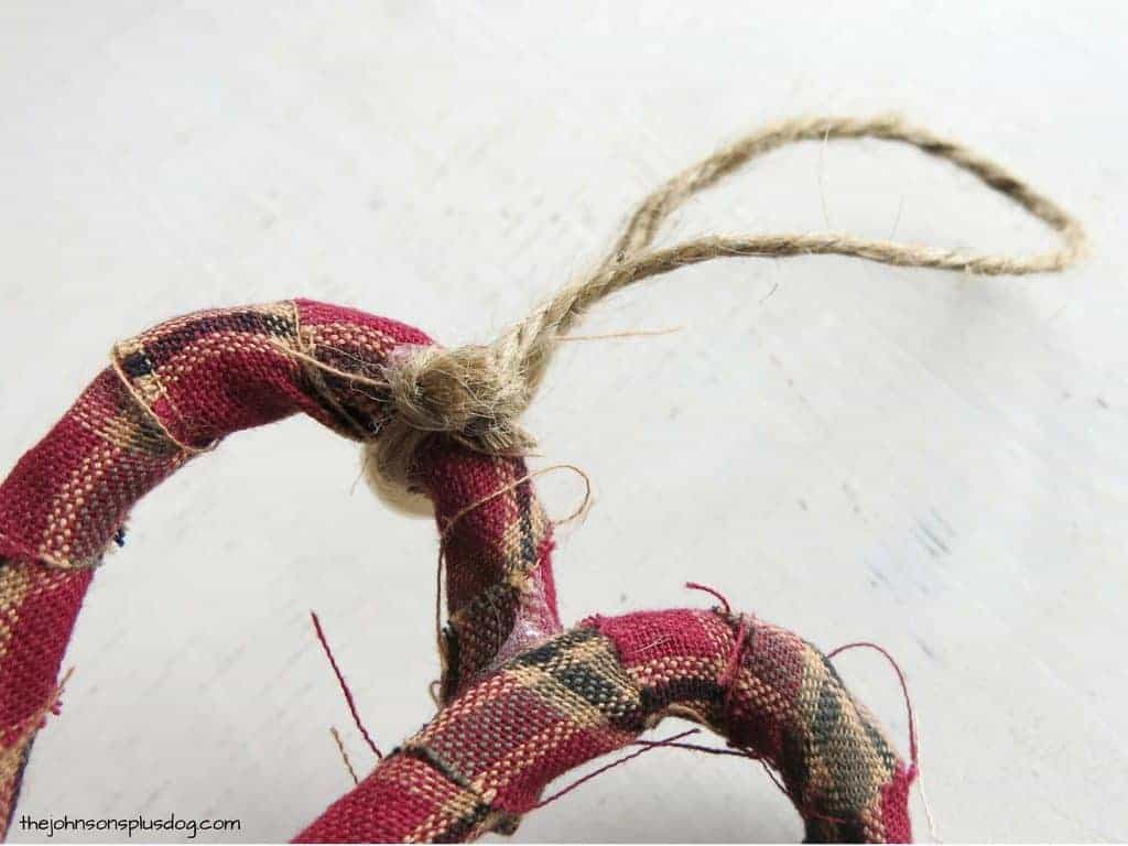 Close up look at the tied jute string hanger attached to the candy cane fabric ornaments.