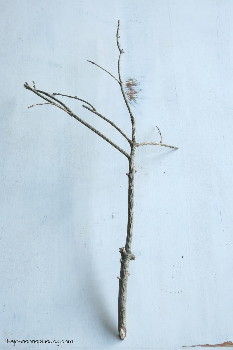 Remove the greenery from the tree twigs, prepping it to make faux cotton stems