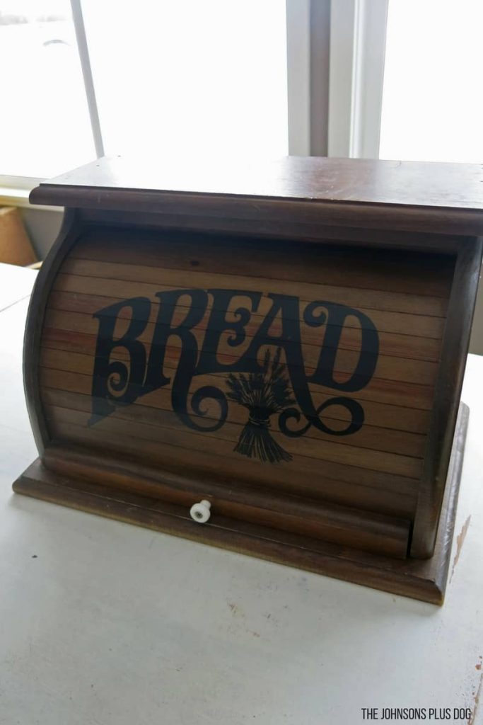 A look at my thrifted vintage bread box before it's chalk paint makeover. This bread box is made with dark stained wood and has the word "bread" painted on the sliding door.