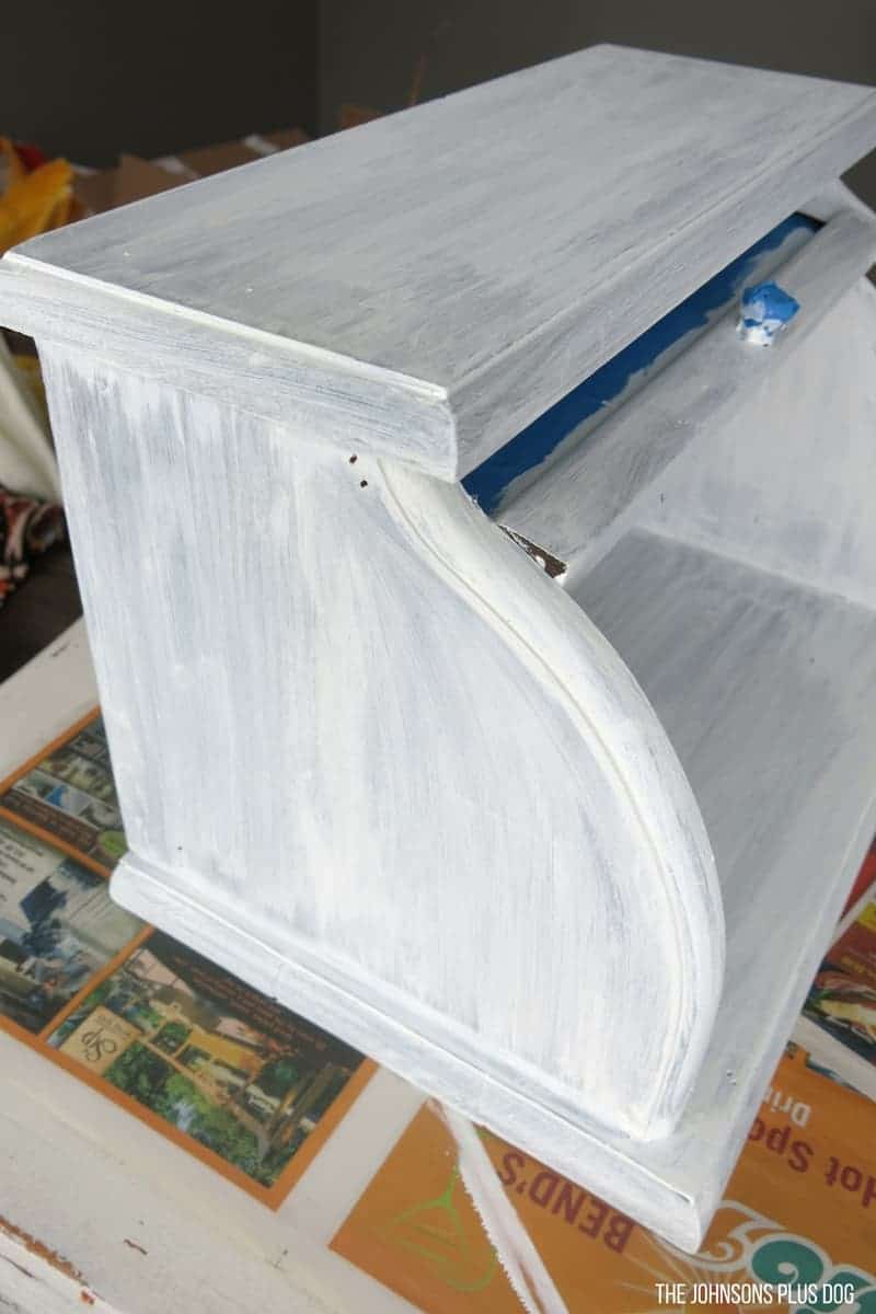 A look at the side and inside of our vintage bread box after two coats of chalk paint. You can still see the darkness of the original finish through the streaky chalk paint coverage.