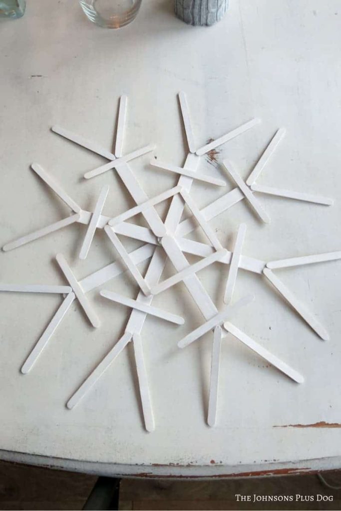 Snowflake made out of attached painted popsicle sticks