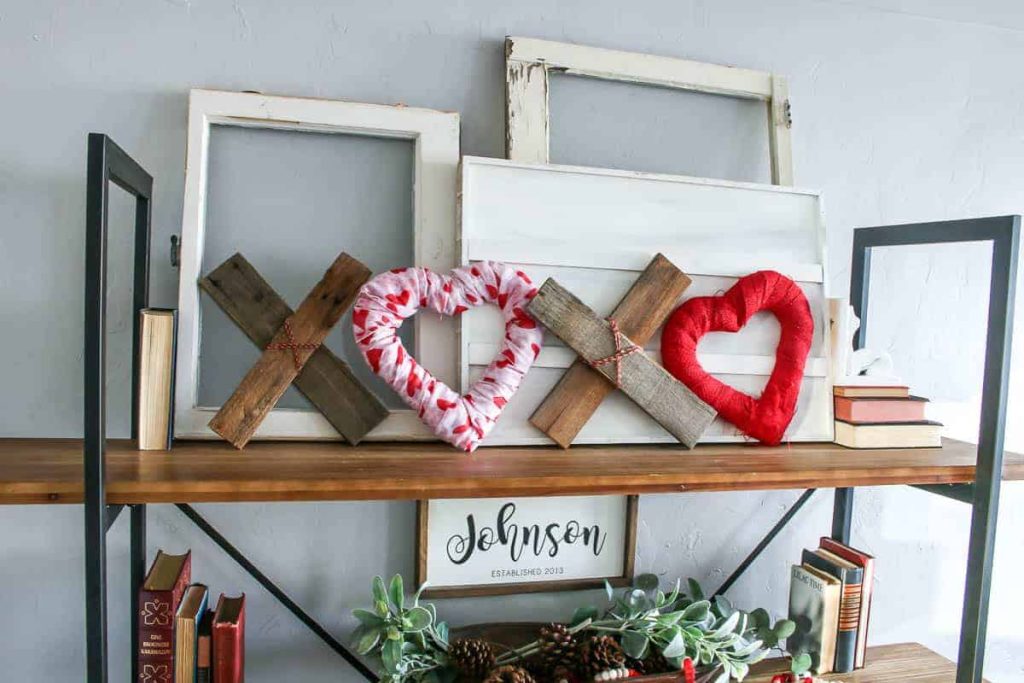 DIY wooden Valentine's Day XOXO decor on the top shelf.