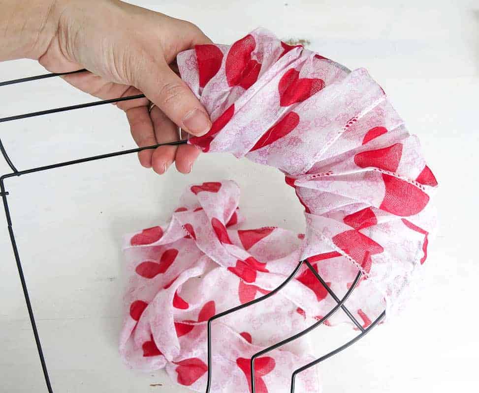 Wrap a Xoxo Decor heart wreath forms from Dollar Tree with printed scarves for a quick and easy way to decorate for Valentine's Day