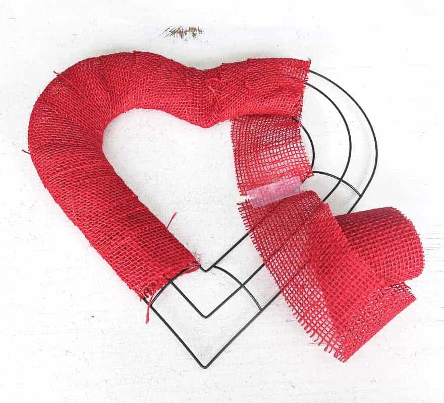 Cover a wire heart wreath form with red burlap ribbon for DIY XOXO Decor for Valentine's Day decorations