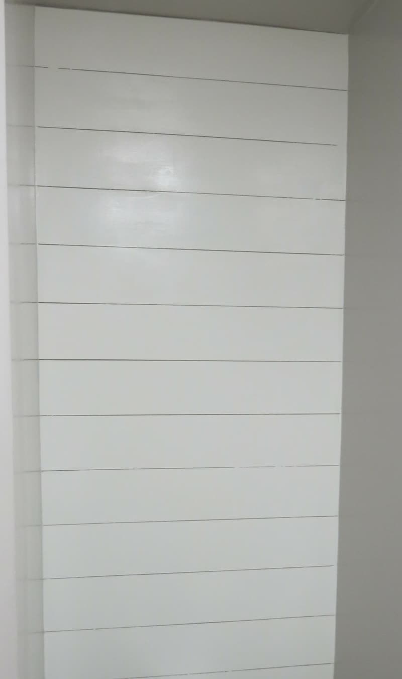 Faux white shiplap walls installed in our fixer-upper's master bathroom.