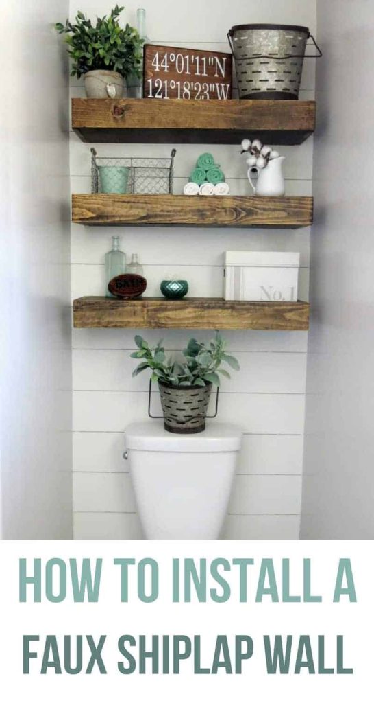 A shiplap wall installed behind a toilet with wooden floating shelves on the wall with text overlay that says how to install a faux shiplap wall