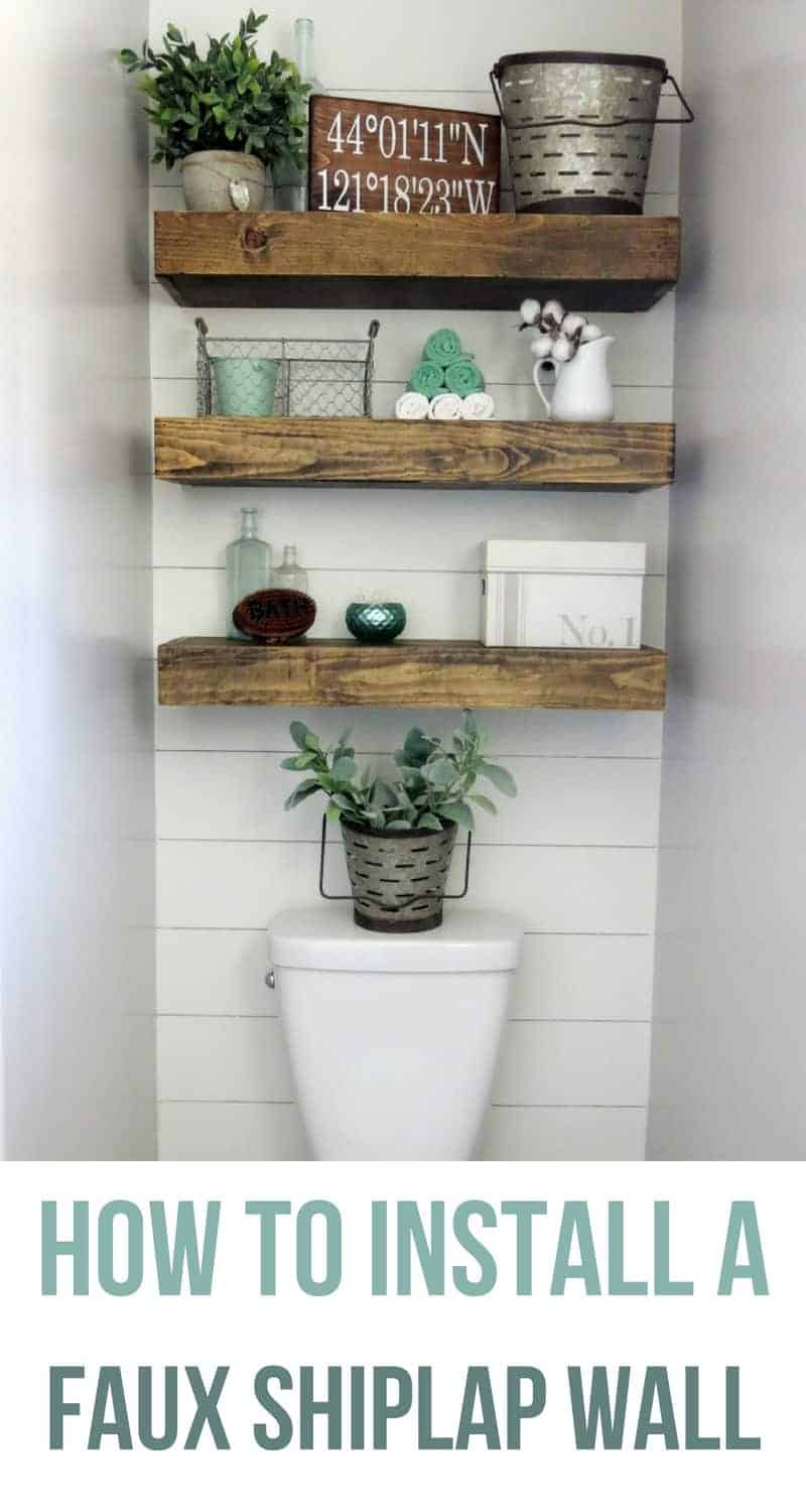 Our new bathroom nook with the faux shiplap wall, floating wood shelves decorated with farmhouse style decor pieces.