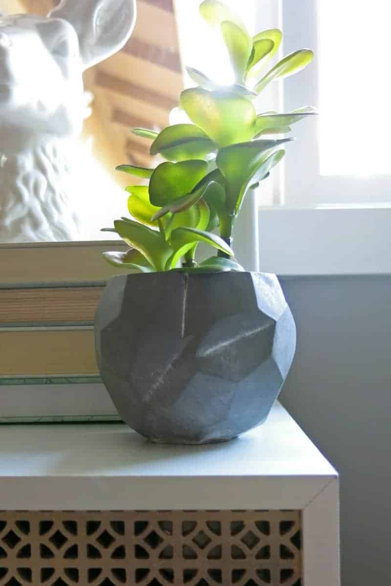 A faux succulent in geometric concrete planter adds a pop of color and style to my home office