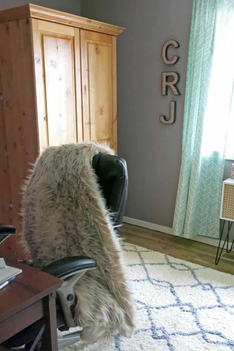 My updated home office has a comfy faux fur throw and mind colored curtains that complement the marble and gold theme