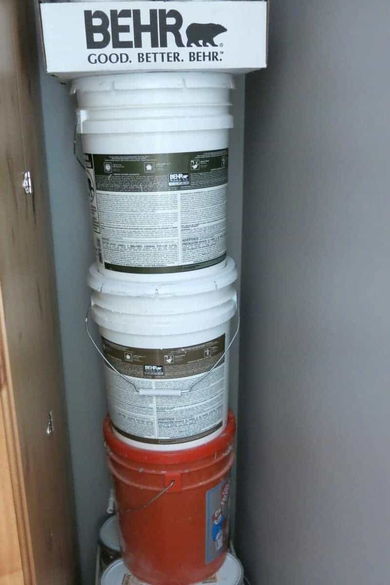 Pales of Behr paint are stacked up behind my crafting cabinet in my home office