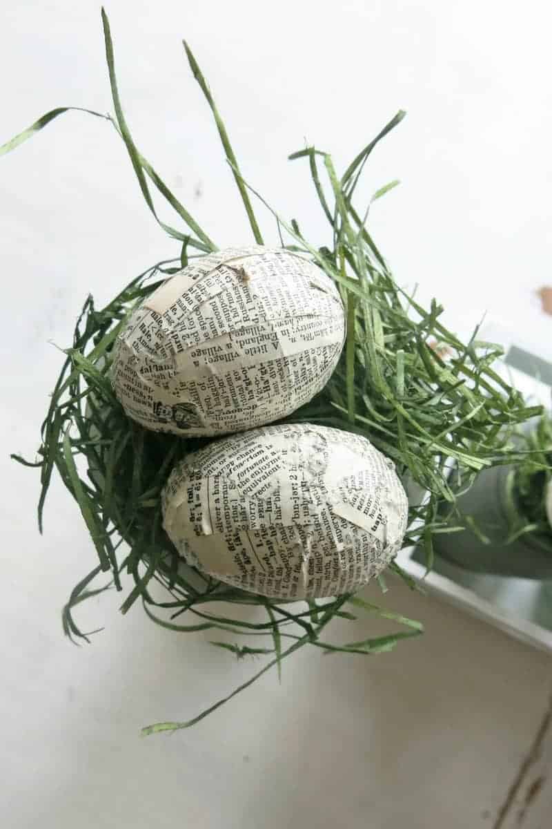 Upcycled plastic Easter eggs decorated with vintage book pages are part of an easy DIY Easter centerpiece